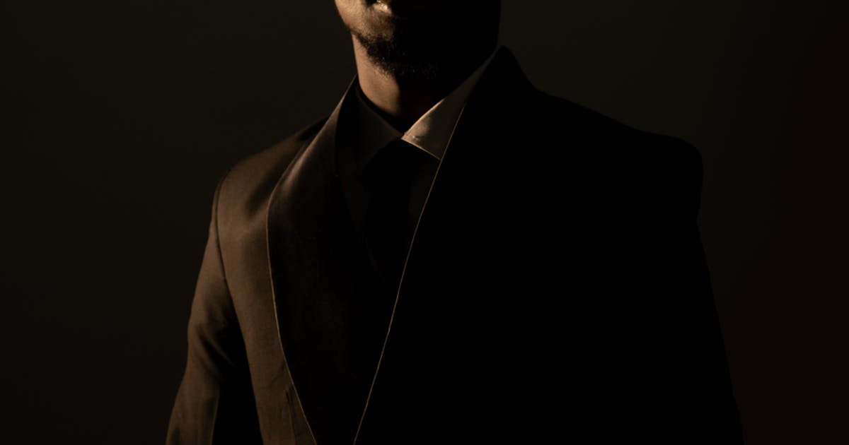 Moody portrait of man in dark suit — premium gift